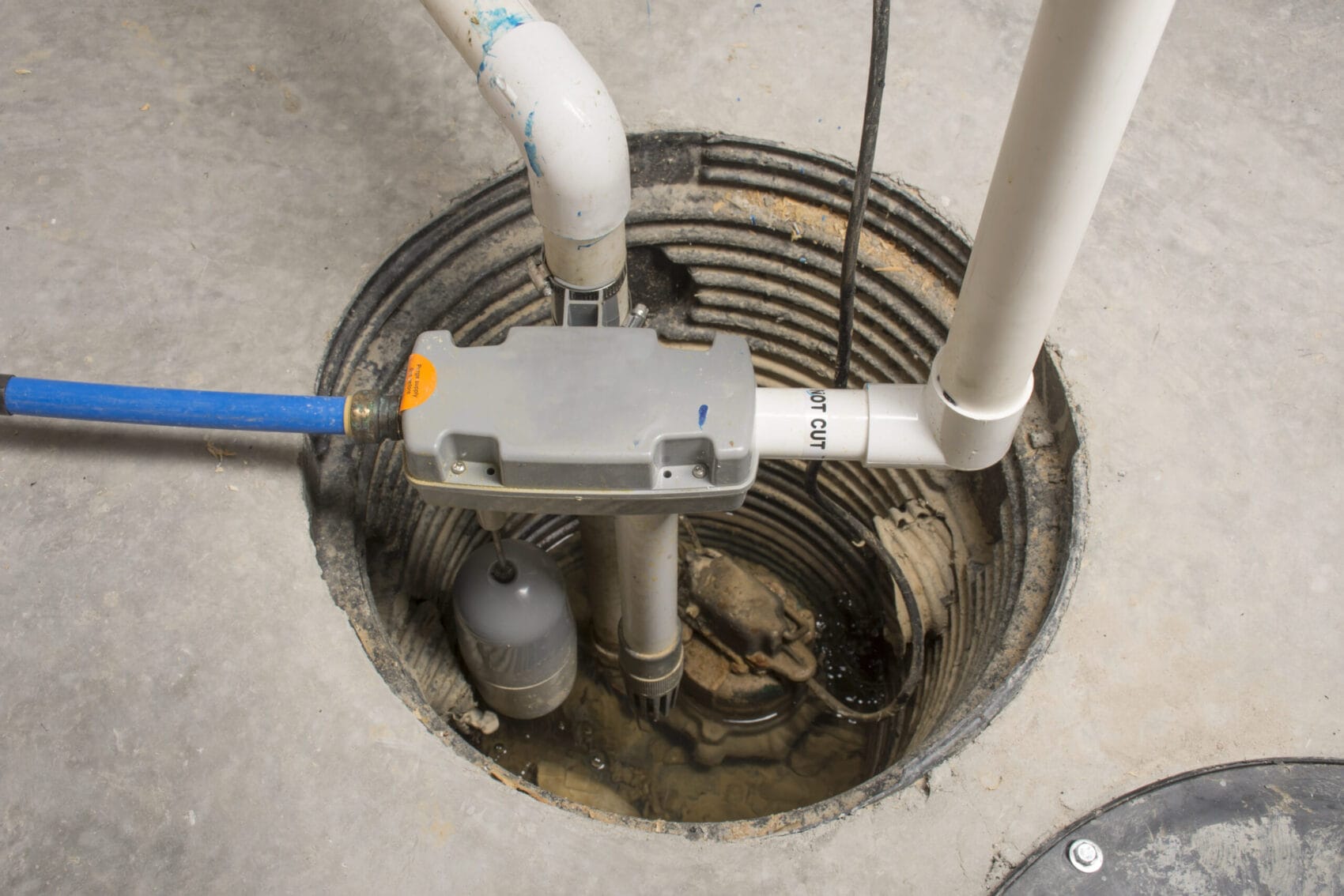 A sump pump installed in a crawlspace of a home with a water powered backup system.